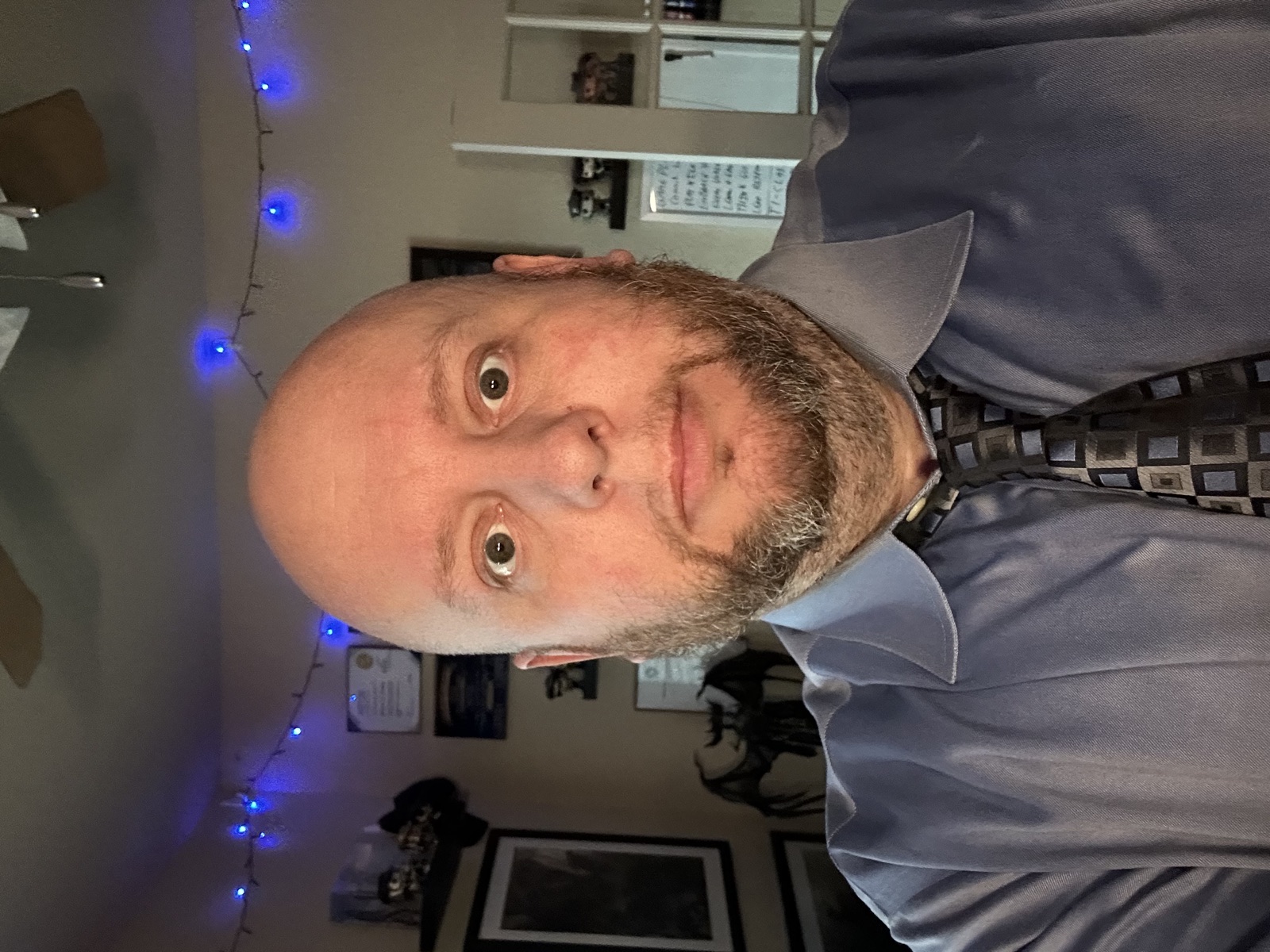 Jeremy D. Pretty wearing a blue dress shirt and patterned tie.